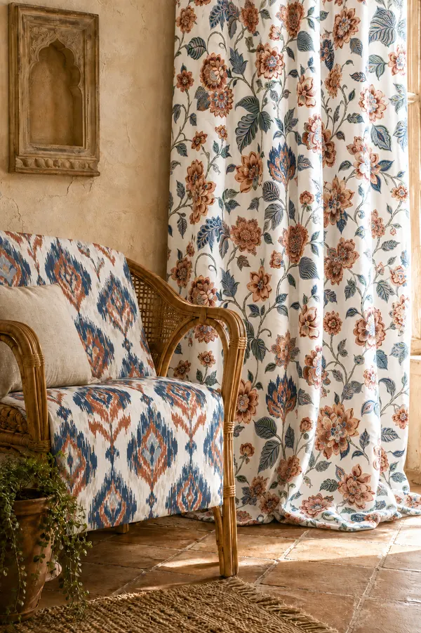 Floral fabric curtains and the matching the wooden Sofa